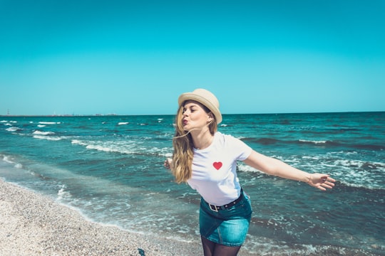 woman standing at the beach during day in Mamaia Romania