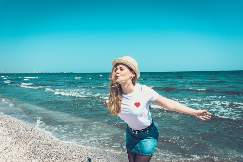 woman standing at the beach during day