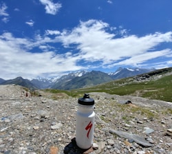 Close-up of a himalpure water bottle with the Himalayan peaks in the background.