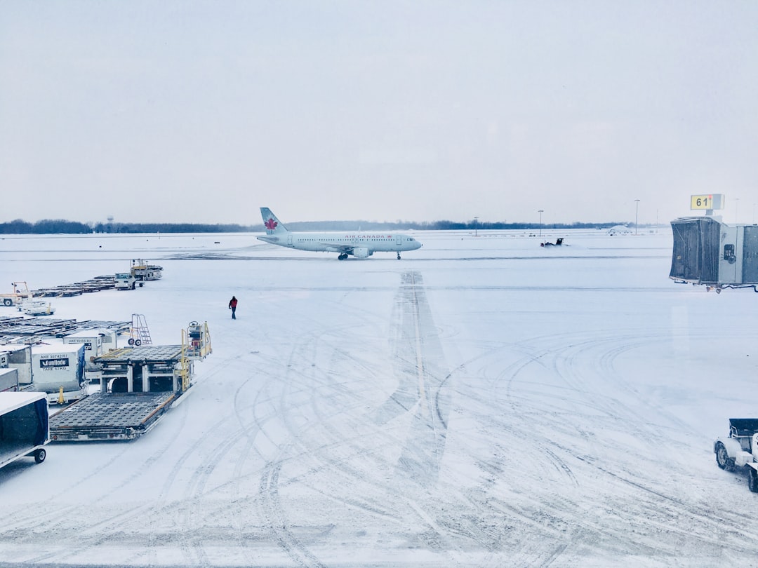airplane on runway in snowy winter weather conditions
