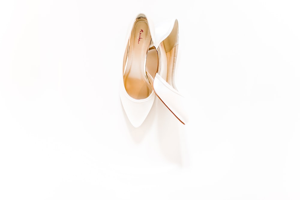 pair of white heeled shoes