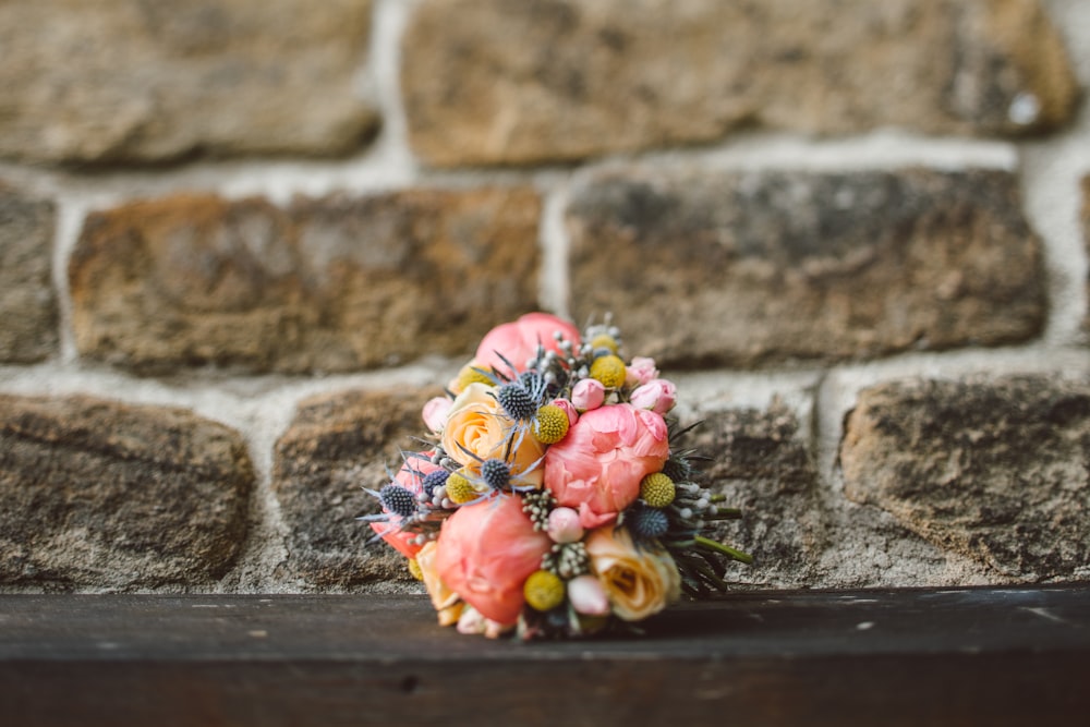 pink and green flowers on brown rack