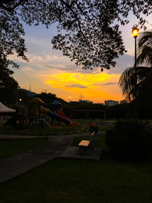 A sunset view of a newly built community learning center with children playing outside.