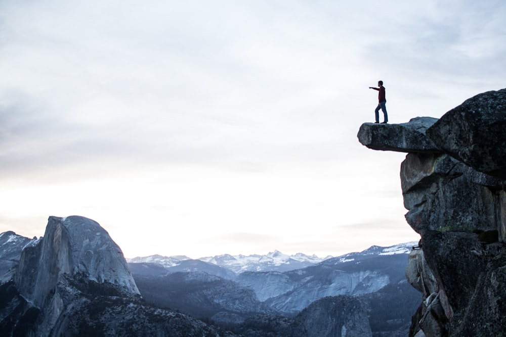 person standing on rocky cliff