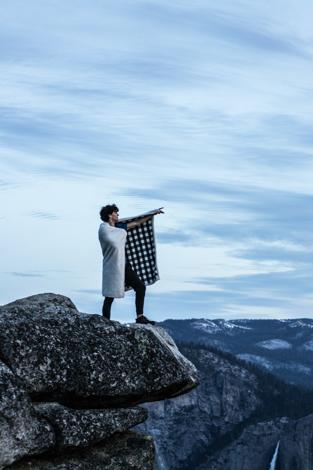 man standing on cliff