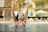 A smiling swimmer emerging from a pool, showing confidence and joy after training.