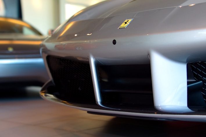 Close-up of a shiny new car bumper displayed on a sleek black background
