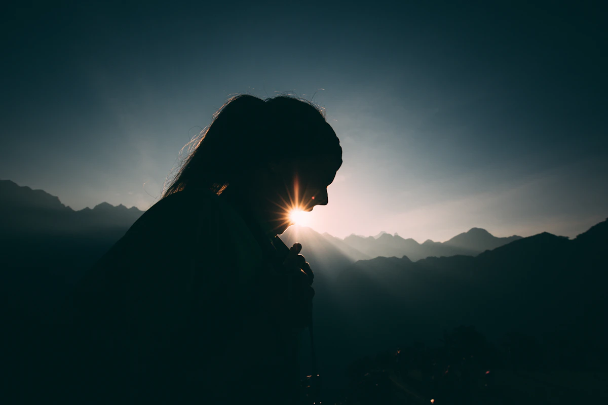 Woman silhouette at sunrise, morning light resets your circadian clock