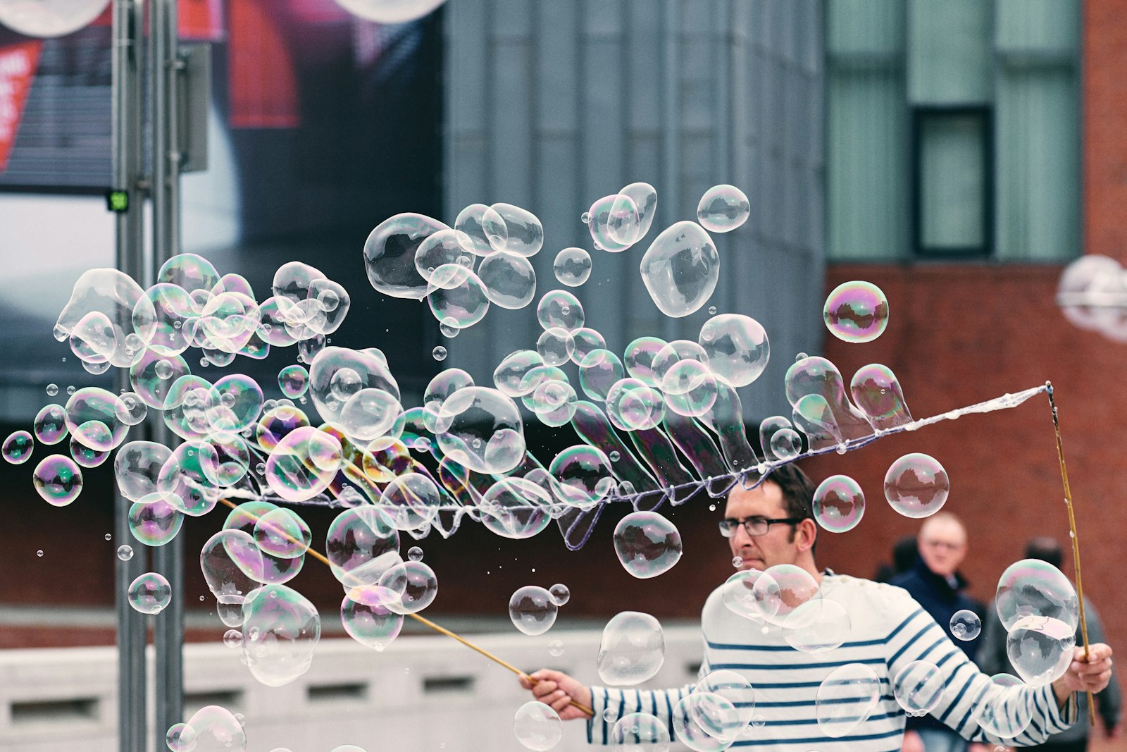 Fujifilm X-T2 + Fujifilm XF 90mm F2 R LM WR sample photo. Man making soap bubbles photography