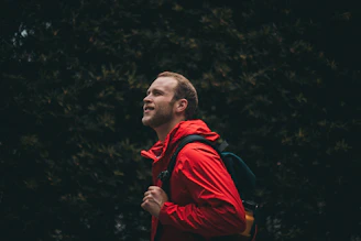 A joyful traveler with a backpack celebrating a year of adventures, symbolizing the annual plan.