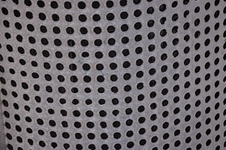 Close-up of microperforated metal panel showcasing detailed craftsmanship.