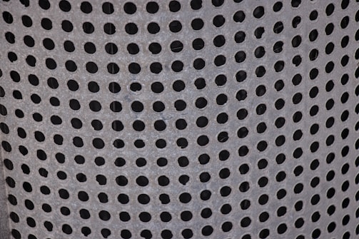 Close-up of microperforated metal panel showcasing detailed craftsmanship.