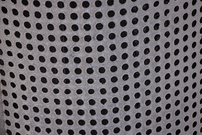 Detailed image showing the perforations and galvanized coating on a cable tray.