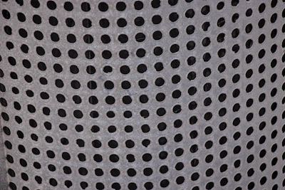 Close-up photo of a sturdy GI perforated cable tray with visible ventilation holes.