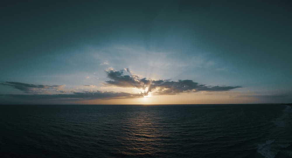 body of water at sunrise