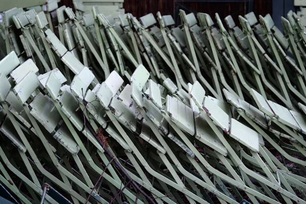 Stacked old metal furniture pieces waiting for same-day pickup service.