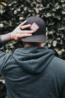 man in black cap and hoodie jacket