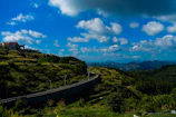 A panoramic view of a winding road cutting through rolling hills captured on a scenic drive.