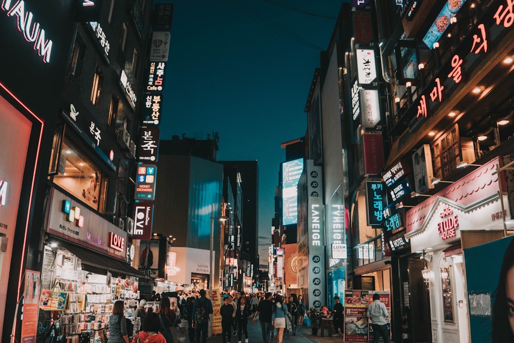 people walking between tall buildings