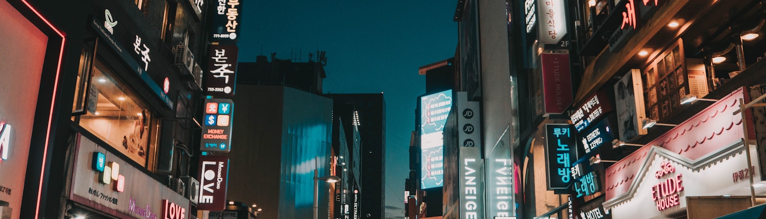 people walking between tall buildings