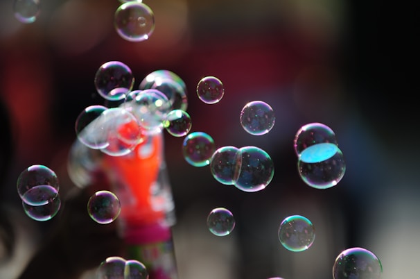 Close-up of a bubble machine creating a stream of shimmering bubbles at a lively party