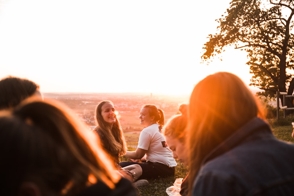 people gathered on open field during golden hour