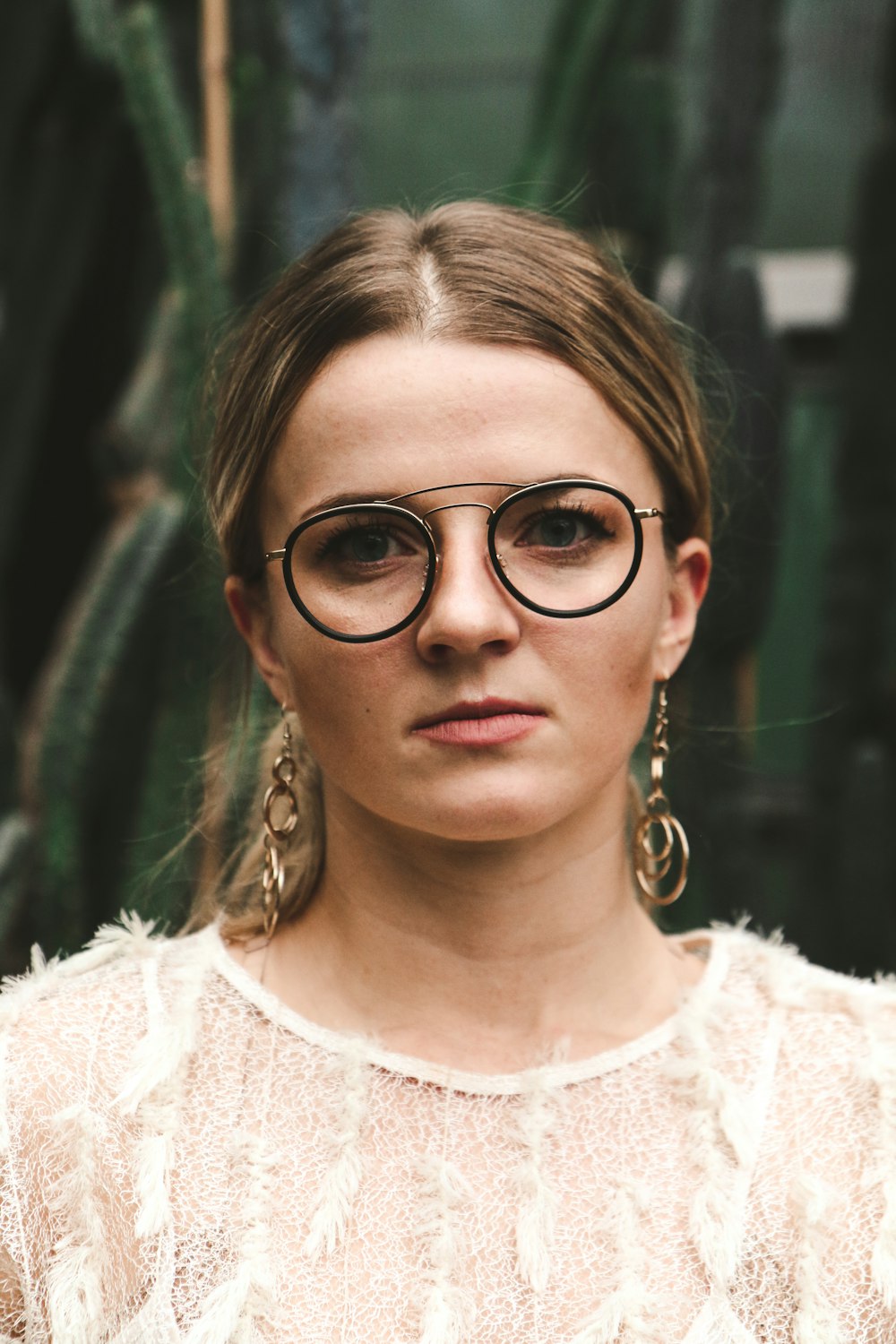 woman wearing eyeglasses and white lace top