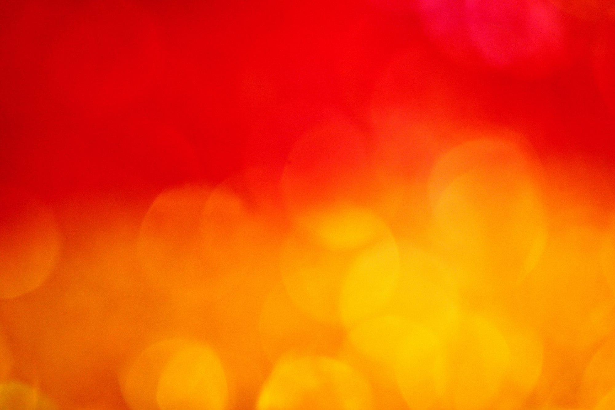 Warm red and orange bokeh fire background wallpaper.