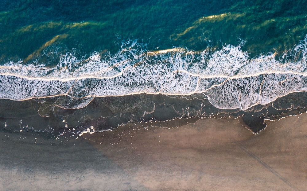 Vista a volo d'uccello della riva del mare che incontra la sabbia