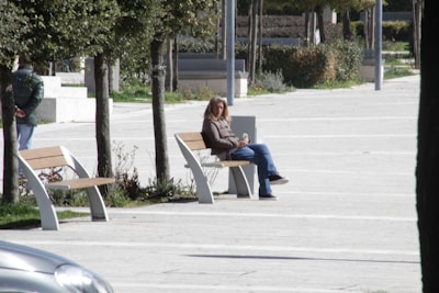 An urbanecho speaker on a park bench with a person jogging nearby, capturing the spirit of active city living.