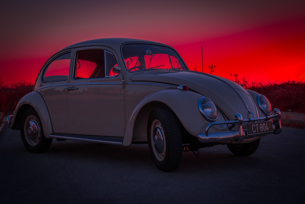 white Volkswagen Beetle on road way