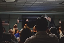people holding flag of U.S.A miniature