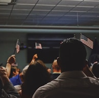 people holding flag of U.S.A miniature