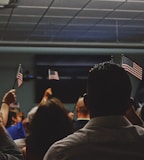 people holding flag of U.S.A miniature