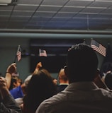 people holding flag of U.S.A miniature