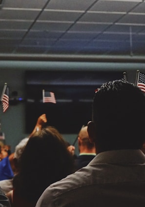 people holding flag of U.S.A miniature