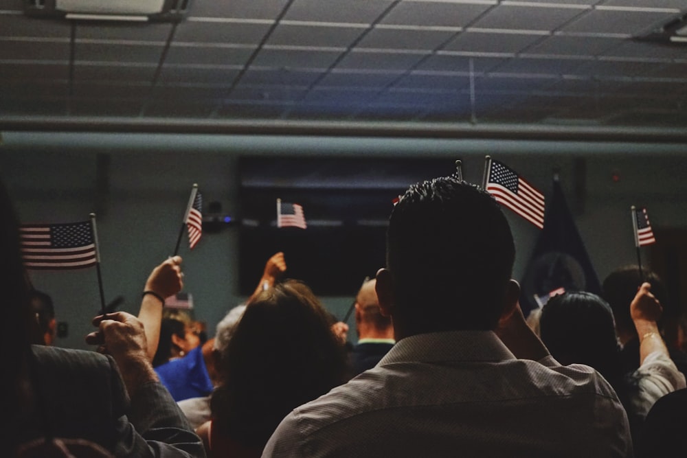 people holding flag of U.S.A miniature