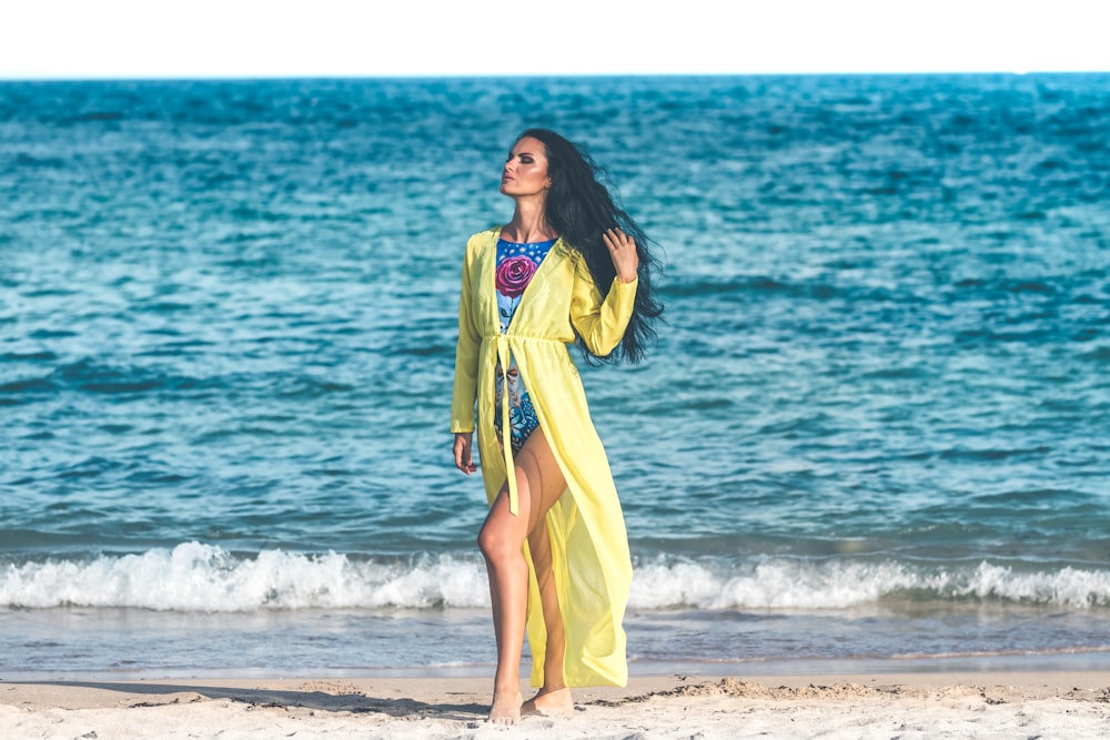 woman standing on seashore at dayime