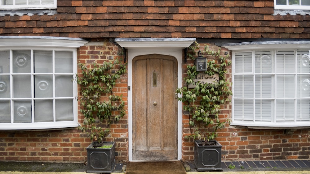 brown brick house with closed door and windows