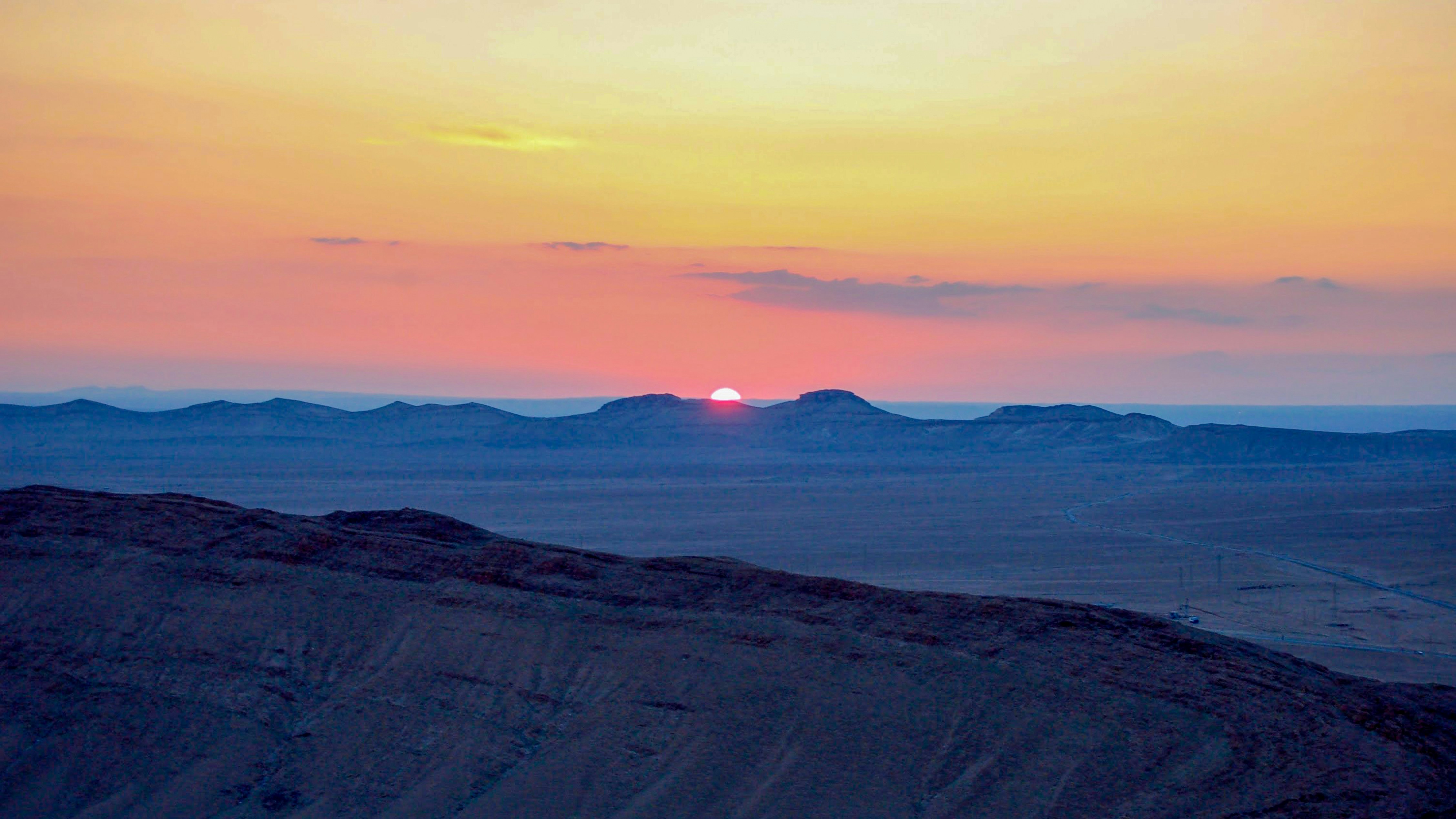 landscape photograph of mountain ranges during golden hour syria teams background