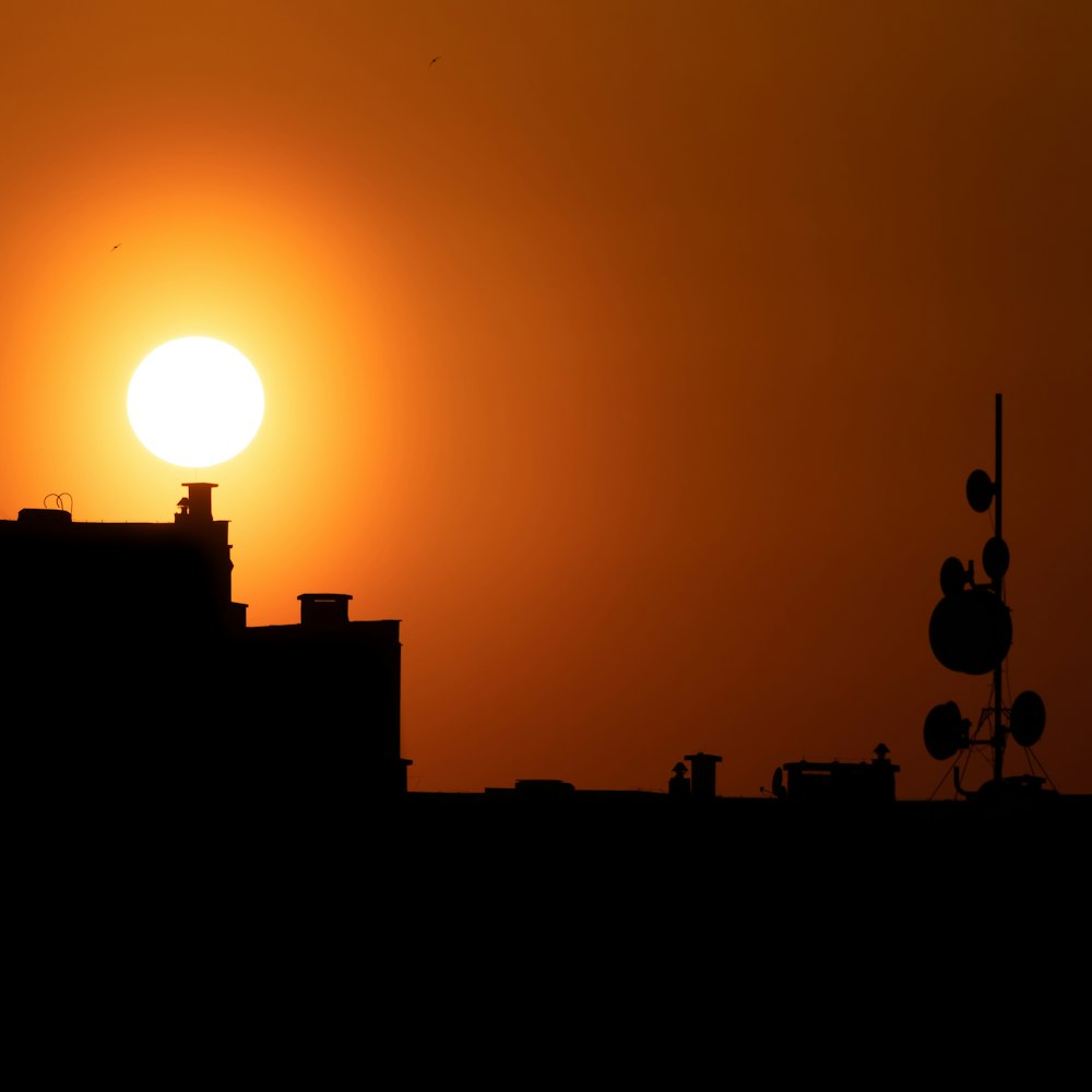 silhouette of building and satellite dish