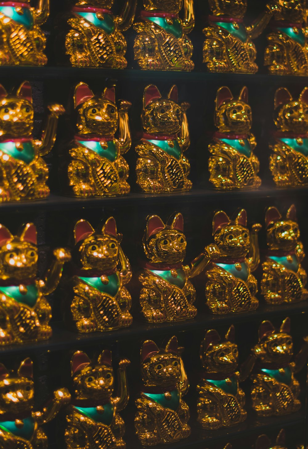 display of gold lucky cat figurines