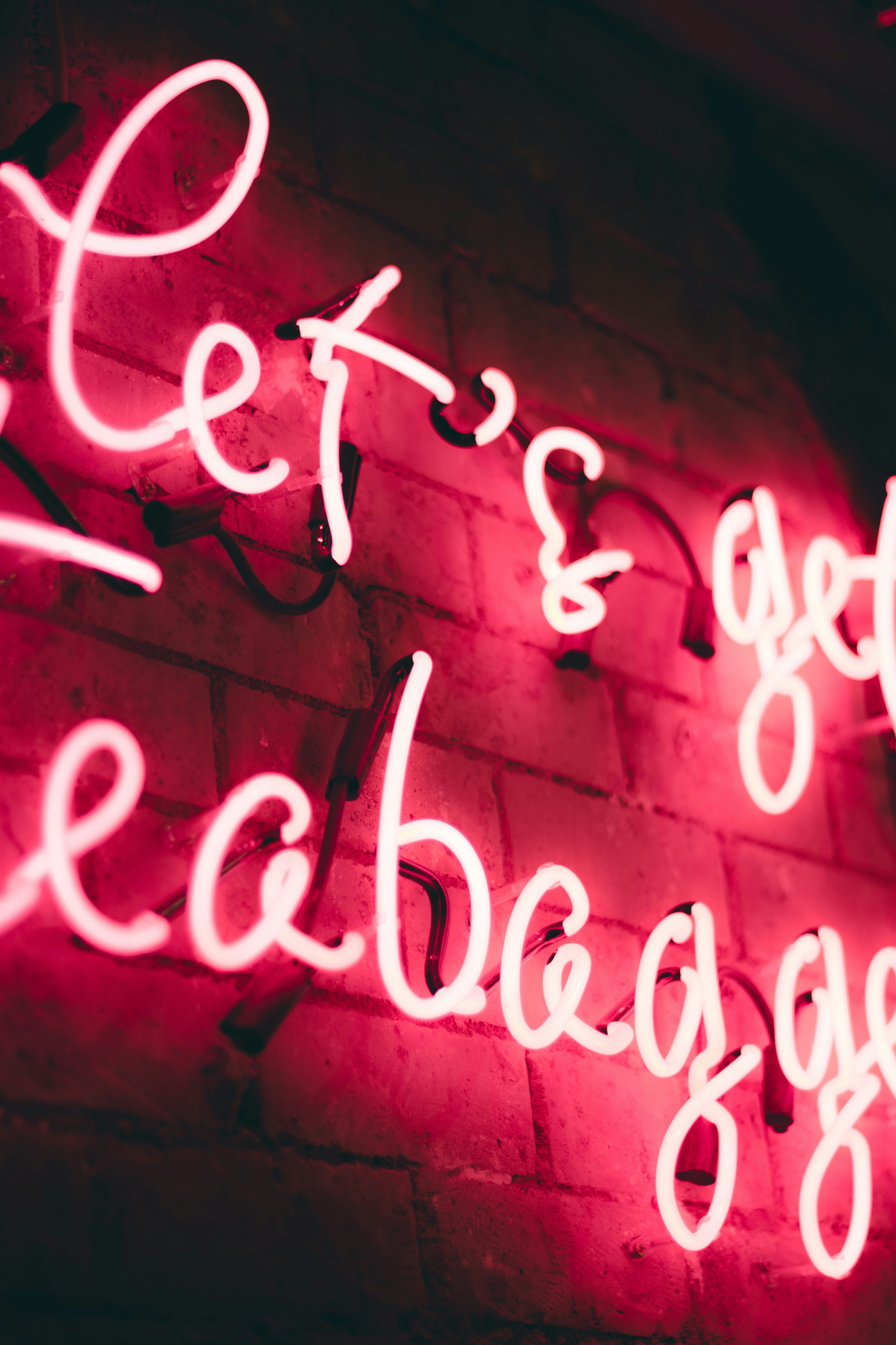 red LED signage on concrete wall