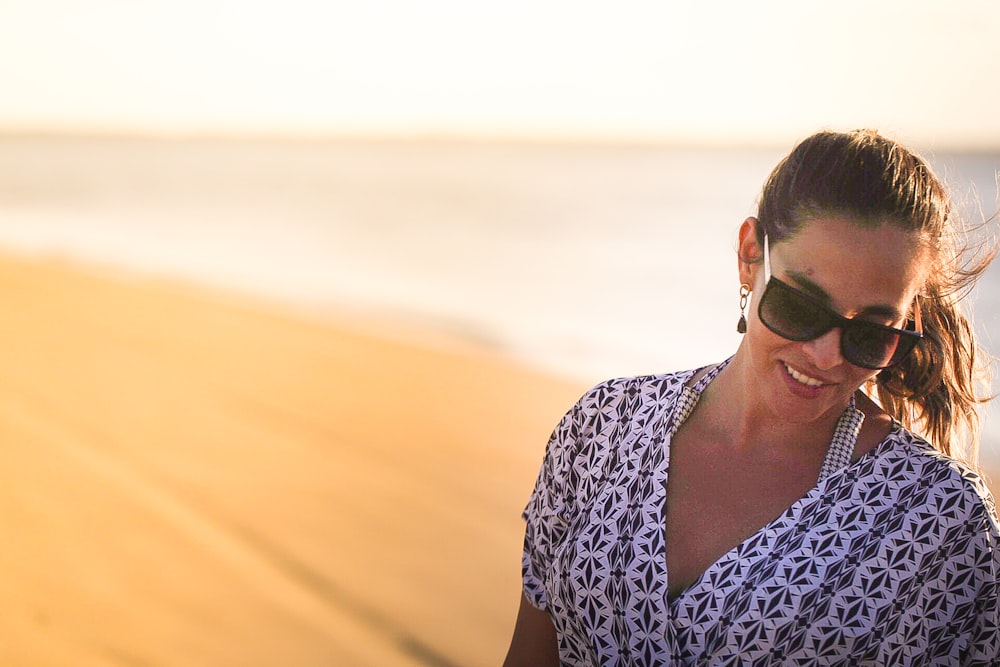 woman standing in seashore during day time