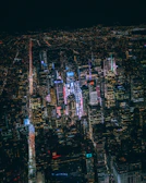 A wide-angle view of a bustling city street at night.