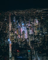An aerial view of a bustling city skyline at night.