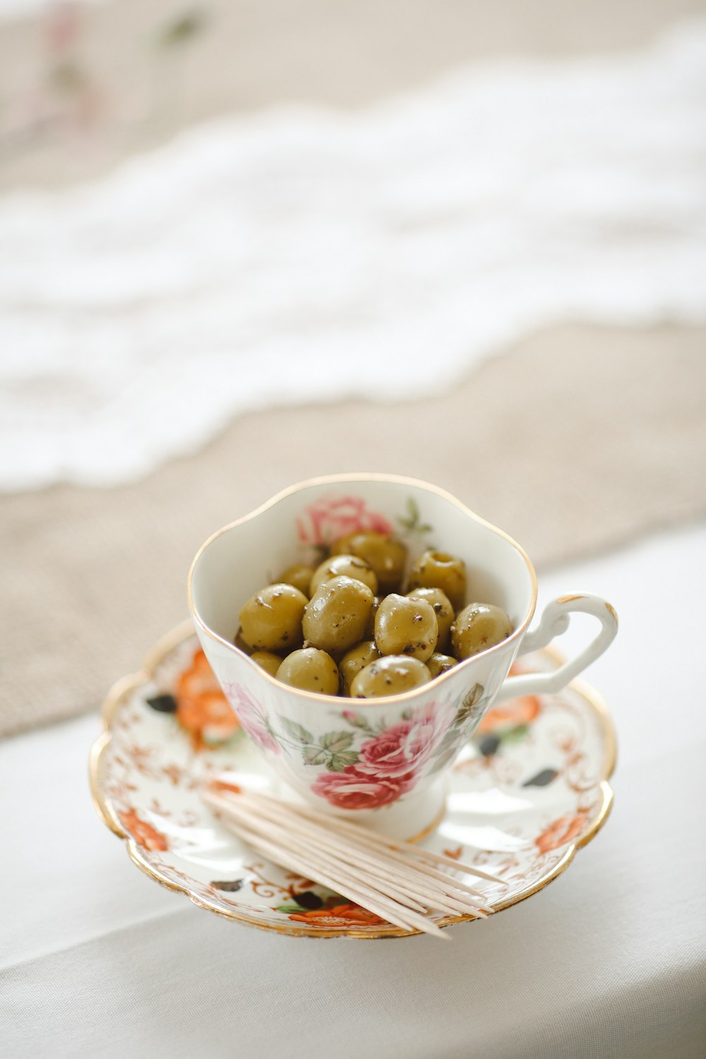 saucer plate with cup, beans and stick