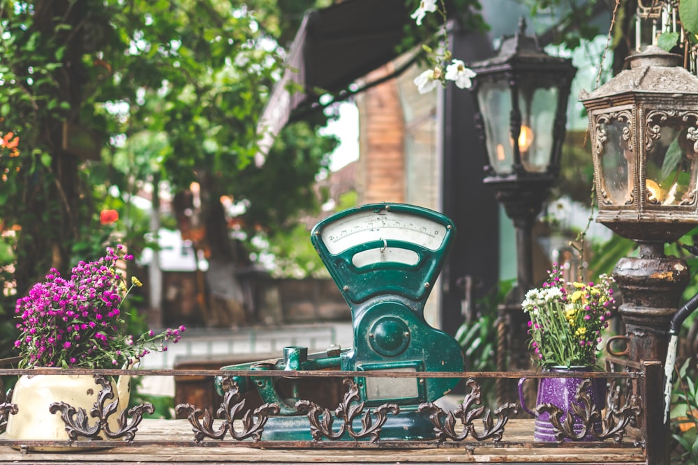 photo of green device near flowers