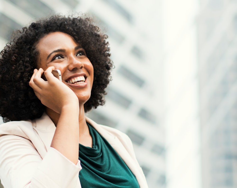 smiling woman talking to the smartphone