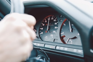 A close-up of a steering wheel and dashboard of a car.